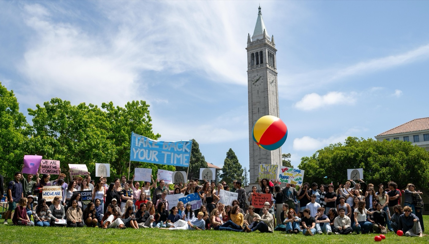 Students rallying on the lawn below the Berkeley Campanile with a Take Back Your Time banner